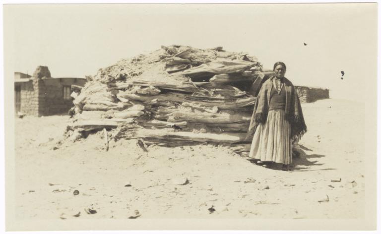 Navajo Woman Standing in front of a Hogan, Farmington, New Mexico