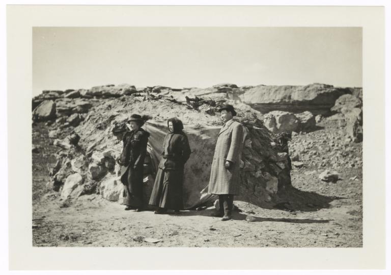 Two Women and a Man Standing near a Rocky Outcropping