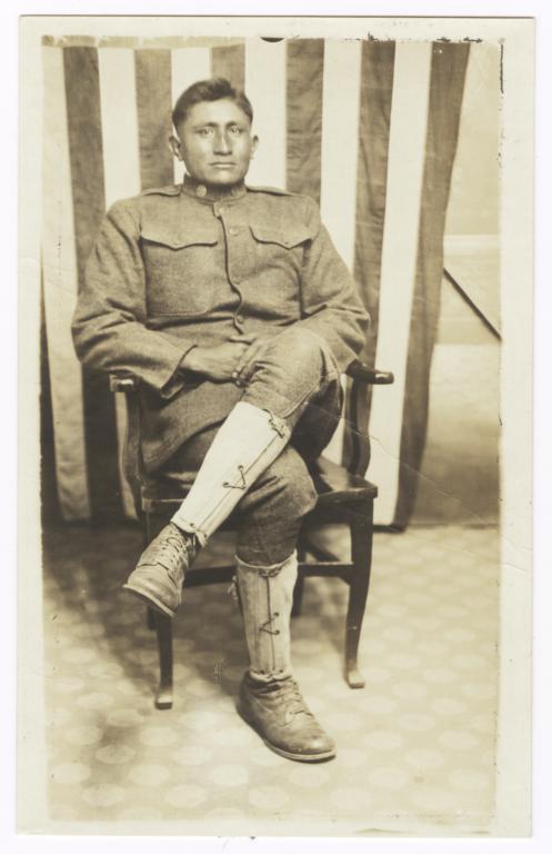 Sam Sevaskeoyame, a Walapai Indian, in Uniform, Posed in front of an American Flag