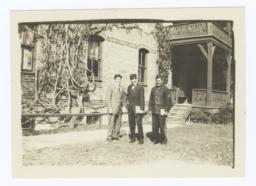 Three Men Standing in front of Side Porch