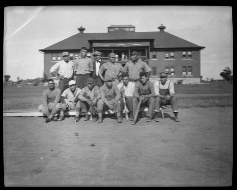 Sports Team Posing in Two Rows on the Field