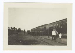 Group of Uniformed Students Entering a Train Car; from a Distance