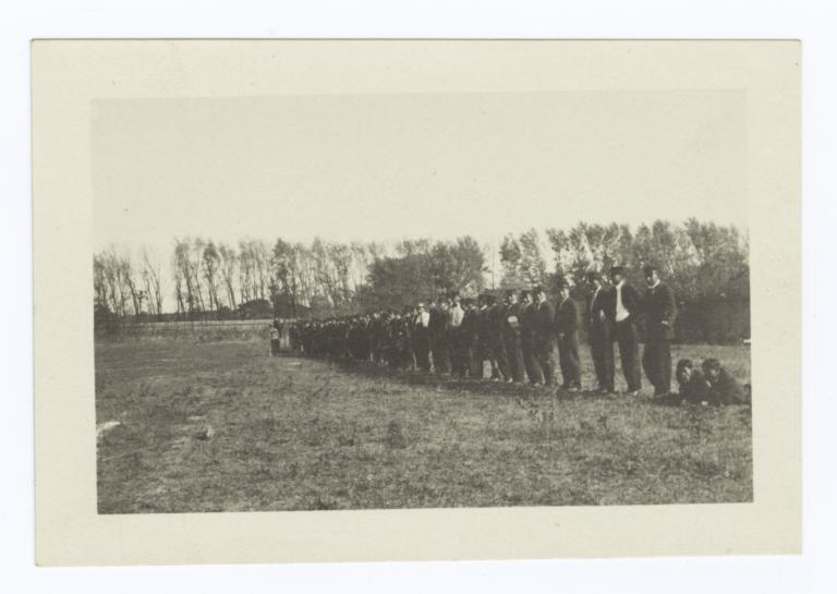 Line of Students in Uniform Standing along the Edge of the Field