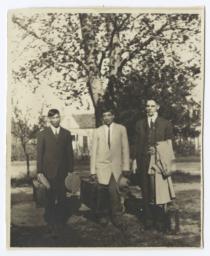 Three Men in Suits Ready for Travel