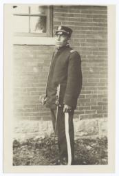 Young Man in Uniform Holding a Sword