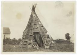 Reverend and Mrs. John Silas in Front of Birch Bark Tipi, near Mikado, Michigan