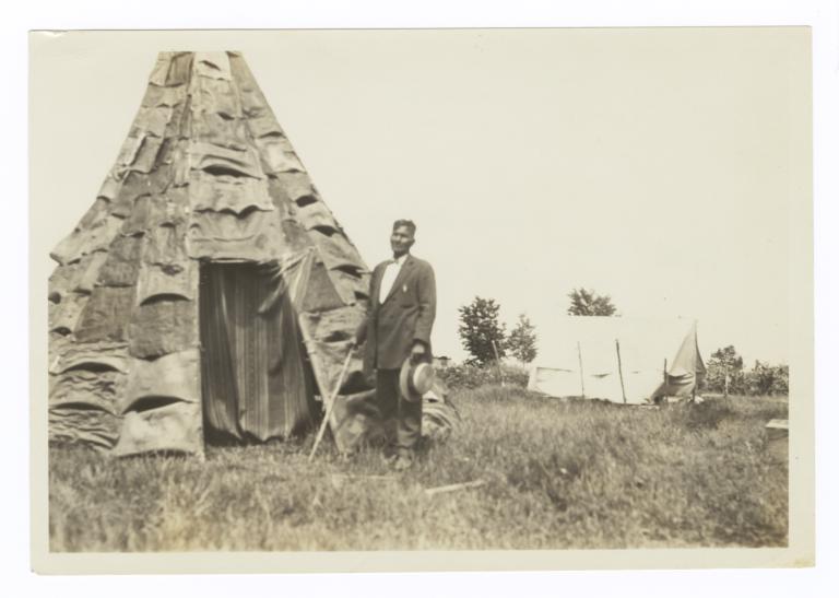 Reverend Simon Greensky in front of a Birch Bark Teepee at His Home near Mikado, Michigan