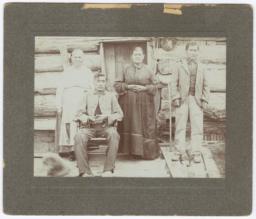 Four Older Ojibwa Indians in front of a Log Home
