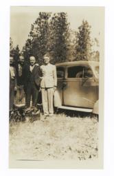 G.E.E. Lindquist and Three Other Men Next to a Car
