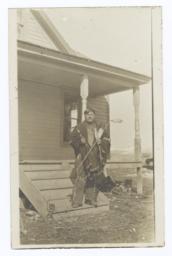 American Indian Man Posing in Front of a House
