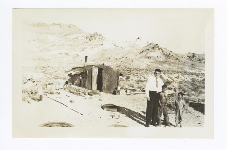 Reverend Floyd O. Burnett and Two American Indian Boys in front of Shack, Beatty, Nevada