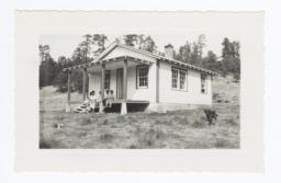Mescalero Family and Their Dog in front of House