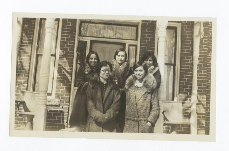 Five Women in Coats Posing on the Porch