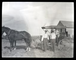 Horse and Buggy with Several People Standing around It