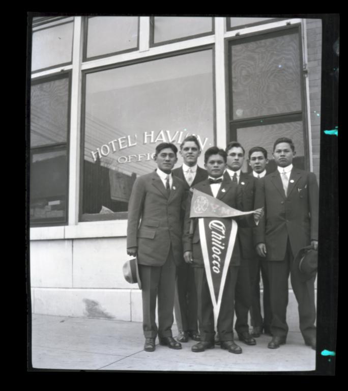 Young Men Holding Chilocco and YMCA Pennants Standing in front of the Hotel Havlin