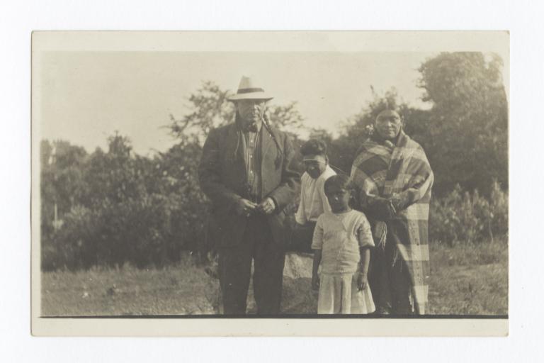 Native American Man, Woman and Young Girl and Boy Standing Outdoors