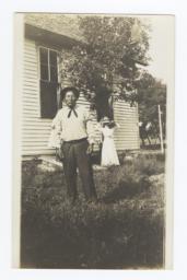 Fort Sill Apache Man and Woman Standing in the Yard of a House