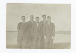 Five Men Wearing Suits and Ties Posed Standing Next to a Small Pond or Lake 