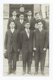 Small Group of Men Standing on Steps Wearing Suits and Ties