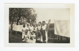 Group of Girls with Irons and Laundry
