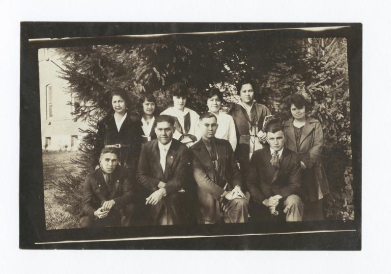 Group of Young People Posing in front of Foliage