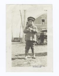 Young Child with Braided Hair under a Hat, and Wearing Cowboy Boots, South Dakota