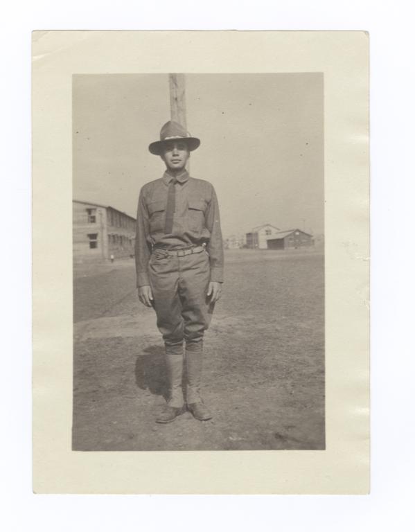 Soldier Standing in front of Flag Pole