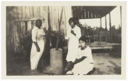 Three American Indian Women Pounding Corn in a Hominy Mortar