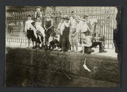 Boys Against Iron Fence