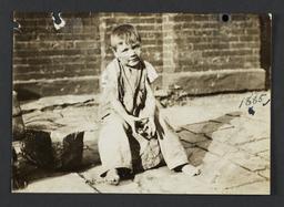 Boy Sitting on Paving Stone