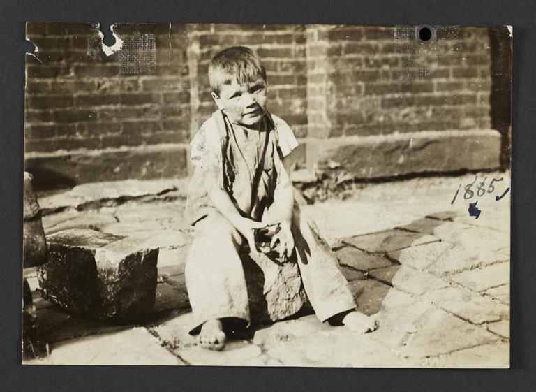 Boy Sitting on Paving Stone