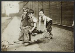 Three Children with Home-Made Scooter