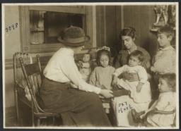 Mulberry Health Center Album -- Nurse with Mother and Children