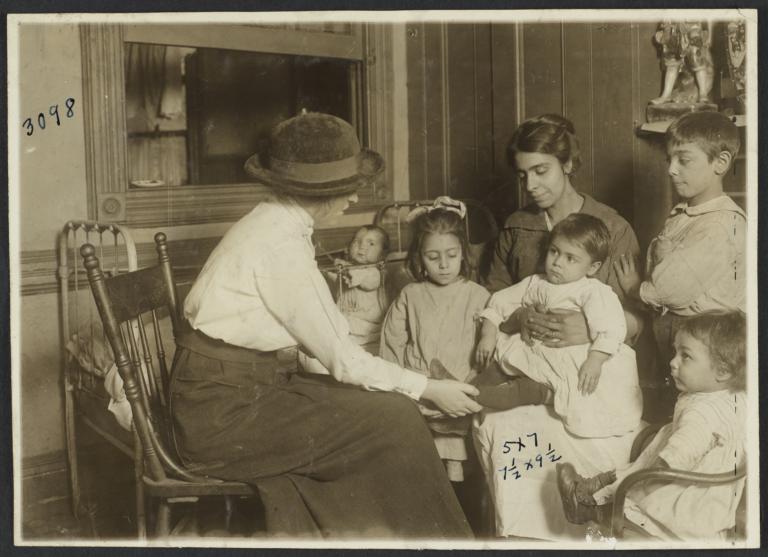 Mulberry Health Center Album -- Nurse with Mother and Children