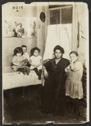 Woman with Four Children near Table