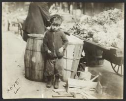 Boy near Barrels and Pushcart