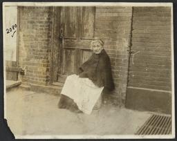 Old Woman Sitting near Door