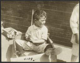 Boy Sitting in Cardboard Box