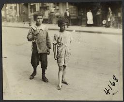 Barefoot Boy and Boy in Shoes on Sidewalk