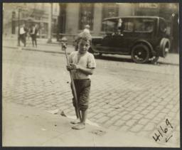 Boy with Stick on Curb
