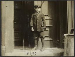 Boy Standing at Entrance to Building