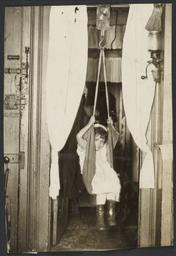 Mulberry Health Center Album -- Child in Hanging Scale