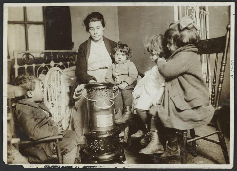 Woman  with Four Children Around Heater