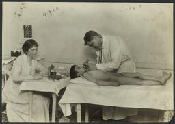 Mulberry Health Center Album -- Doctor Examining Boy