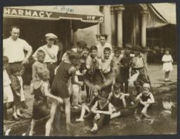 Children Playing in Water on Street