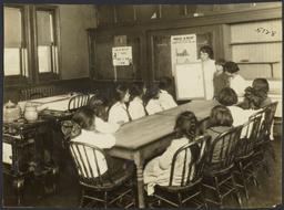 Mulberry Health Center Album -- Woman Teaching Class of Children