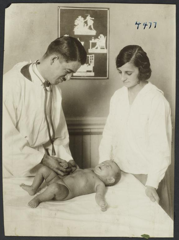 Mulberry Health Center Album -- Doctor with Woman and Baby