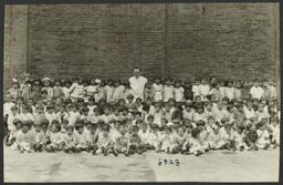 Mulberry Health Center Album -- Man with Large Group of Children