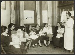 Mulberry Health Center Album -- Woman  Showing Medicine to Mothers and Children