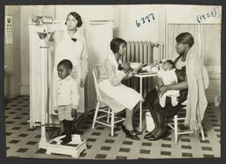 Columbus Hill Health Center Album -- Weighing Child at Columbus Hill Health Center